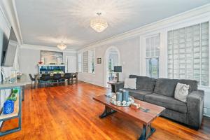 a living room with a couch and a table at Sinatra House Down Walk to Pleasure Pier and Fun in Galveston