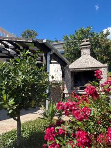 un alimentador de aves en un jardín con flores rosas en Adriatic Pearl, en Dramalj