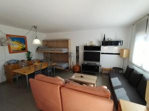 a living room with a couch and a table at Puerto Rico 6 in Empuriabrava