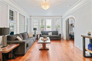 a living room with a couch and a table at Sinatra House: Mardi Gras Parade Route in Galveston