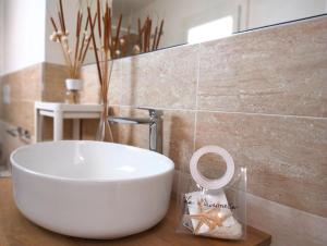 a bathroom with a white bowl sink on a counter at La Maisonette - Centro storico in La Maddalena +142 photos