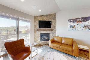 a living room with a couch and a fireplace at High Line View in Kamas
