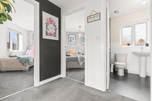 a bathroom with a door open to a bedroom at #16 Detached Stunning Lux 3 Bed home Parking NEC in Marston Green +46 photos
