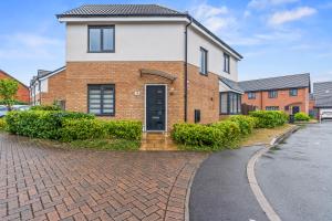 a brick house with a black door on a brick road at #16 Detached Stunning Lux 3 Bed home Parking NEC in Marston Green