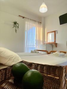a room with two beds and two melons on the floor at Physis Seaside Living in Preveza