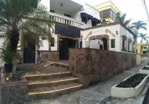 a building with stairs in front of a building at Hotel Maison Gautreaux in Santo Domingo