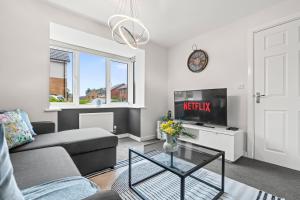 a living room with a couch and a tv at #16 Detached Stunning Lux 3 Bed home Parking NEC in Marston Green