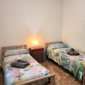 two beds with stuffed animals on them in a room at Casa Eliana Mountain Lake Iseo Hospitality in Sovere