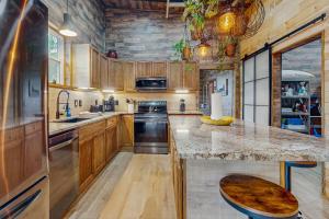 a kitchen with wooden cabinets and a marble counter top at Wolfhaven in Sylva