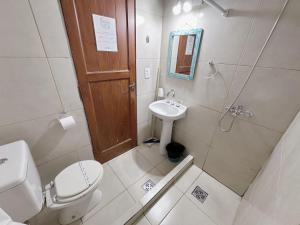 a bathroom with a toilet and a sink and a shower at Hosteria Puyehue in San Carlos de Bariloche