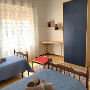 a bedroom with two beds and a large window at Casa Eliana Mountain Lake Iseo Hospitality in Sovere
