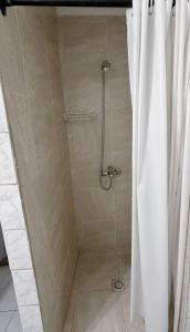 a shower with a shower curtain in a bathroom at Hosteria Puyehue in San Carlos de Bariloche