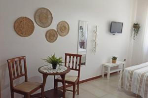 a room with a table and two chairs and a bed at Suite Civico 27 in Ugento