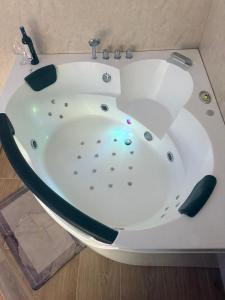 a white bath tub in a bathroom at Secret Spa Nis in Niš