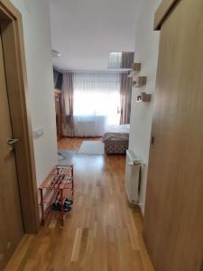 an empty room with a bed and a wooden floor at Secret Spa Nis in Niš