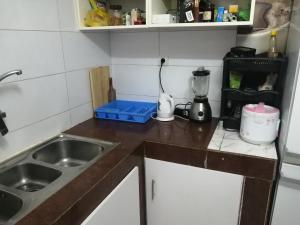 a kitchen with a sink and a counter top at Sacre Coeur Hôte DAKAR in Dakar +3 photos