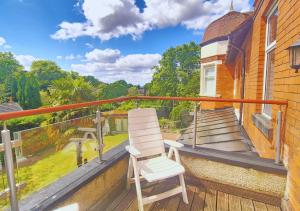 a white chair sitting on the balcony of a house at Stylish & Modern 2BR Flat nr Nottingham City Centre in Nottingham
