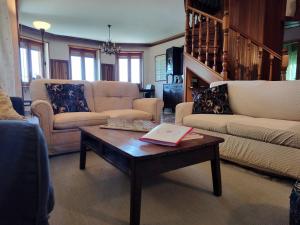 a living room with two couches and a coffee table at Villa Martini dei Rossi in Sanfrè