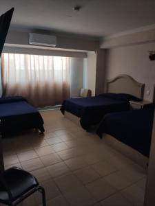 Postel nebo postele na pokoji v ubytování Hotel del Paseo