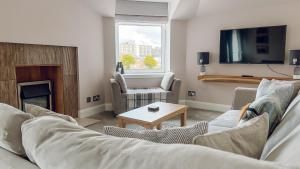 a living room with two couches and a tv at River-View Loft, sleeps 4, with parking in Inverness