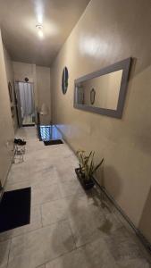 a hallway with a tile floor and a mirror on the wall at Hostel & Privativo in Manaus