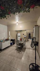 a kitchen with a table and chairs in a room at Hostel & Privativo in Manaus