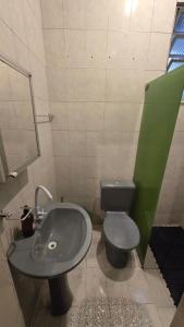 a bathroom with a sink and a toilet at Hostel & Privativo in Manaus