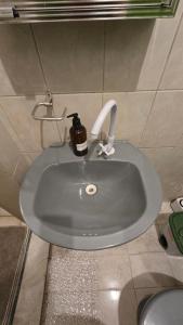 a bathroom sink with a soap dispenser on it at Hostel & Privativo in Manaus +35 photos