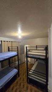 a room with three bunk beds in it at Hostel & Privativo in Manaus