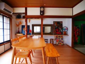 a dining room with a wooden table and chairs at Tsugaru House1 in Aomori