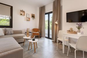 a living room with a couch and a table at Casa al Mare in Nea Roda
