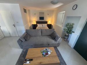 a living room with a couch and a bed at Studio Apartment Krapanj in Krapanj