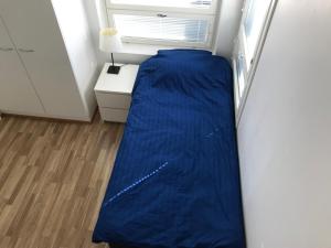 a bed in a room with a window at Budget room in Vaasa