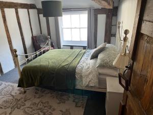 a bedroom with a bed and a window at Harleston Norfolk Suffolk border Historic Cottage in Harleston