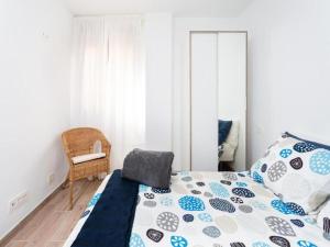 a bedroom with a bed and a chair and a mirror at Trip Medano England Centro in El Médano