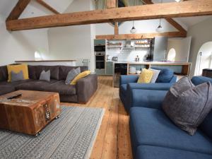 a living room with blue couches and a coffee table at 5 Bed in Abersoch 55385 in Bottwnog
