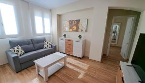 a living room with a couch and a table at Apartamento La Monina CUEVAS DEL VALLE in Cuevas del Valle