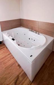 a large white bath tub in a room at Apartamento La Monina CUEVAS DEL VALLE in Cuevas del Valle
