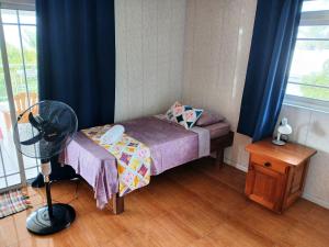 Ένα ή περισσότερα κρεβάτια σε δωμάτιο στο Raiatea Guest