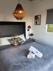 a bedroom with a bed with a towel on it at Bangalô Soberano in Brasilia