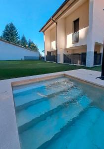 a pool of water in front of a house at Apartamento La Monina CUEVAS DEL VALLE in Cuevas del Valle