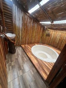 a bathroom with a large tub in a wooden room at Hotel Luna Azul Tatacoa in Villavieja