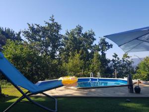 a blue chair sitting next to a swimming pool at Casa Paz in Nigrán