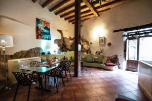 a kitchen with a table and chairs in a room at Casa Fiore del Borgo in Castiglione di Sicilia