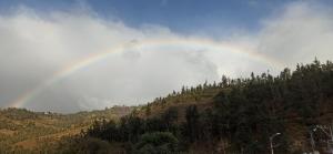 a rainbow in the sky over a mountain at Confortable cabaña campestre in Ibarra +1 photo
