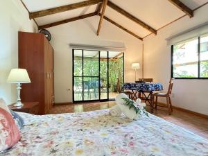 a bedroom with a large bed and a table at Cabañas moeVarua in Hanga Roa