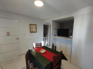 a small dining room with a table and a television at Complejo belgrano in General Roca