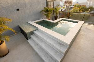 a jacuzzi tub on the roof of a building at Aira Hotel in Sobral