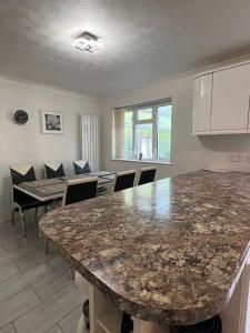 a kitchen with a large marble table and chairs at Spacious 4 bed Farnborough AirShow in Farnborough