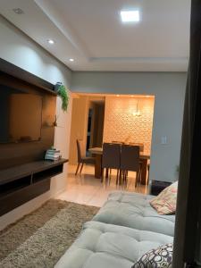 a living room with two beds and a dining room at Casa moderna e confortável 2andar in Leopoldina